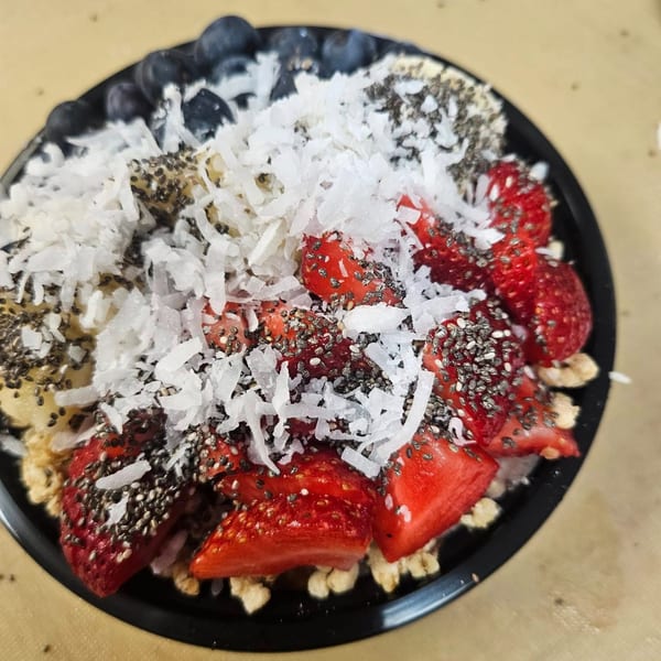 A Coco Loco smoothie bowl with strawberries, blueberries, bananas, shredded coconut, and chia seeds.